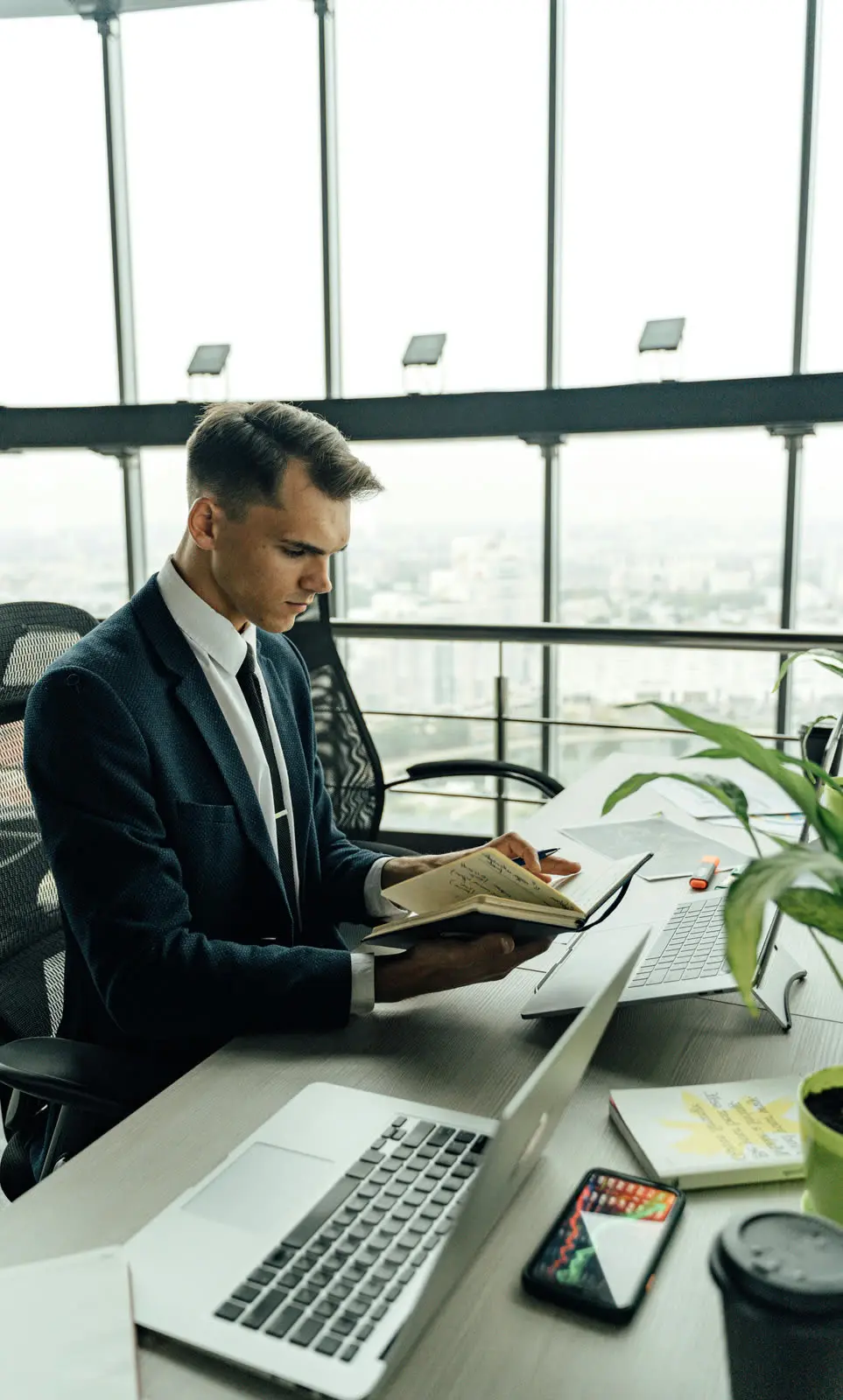 Advisor reviewing notes in a high-rise office